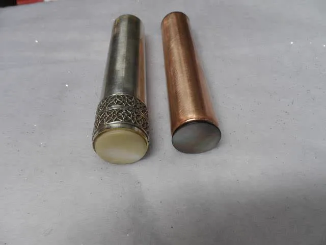 Mother-of-pearl rod caps, one plain and one abalone shell